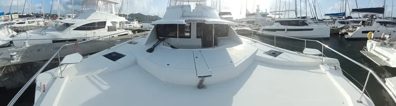 Whimsea II Yacht Photos Pics 2018 Leopard 51 Powercat yacht docked in a marina, surrounded by other boats.