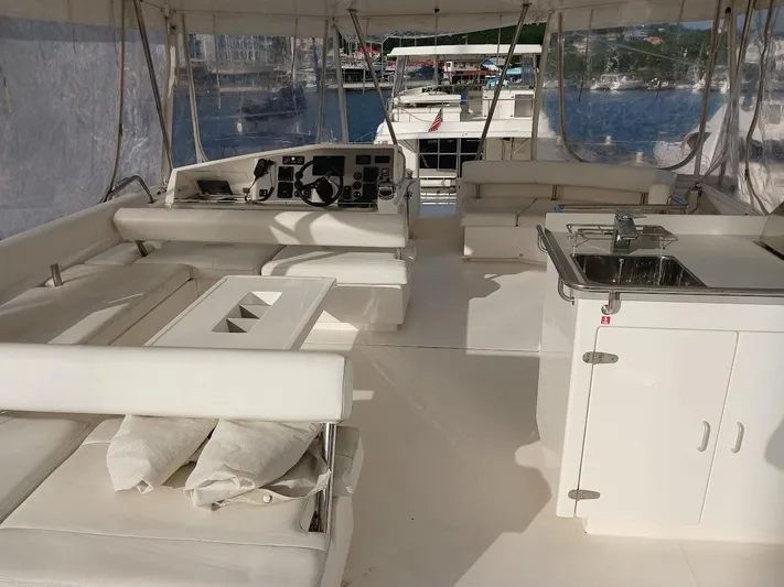 Whimsea II Yacht Photos Pics Spacious interior of 2018 Leopard 51 Powercat yacht with seating and kitchenette.