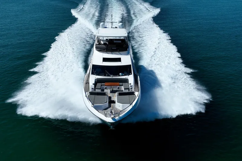 Do It Anyway Yacht Photos Pics 2018 Sunseeker 76 Yacht cruising on open water, creating a dynamic wake.