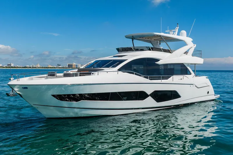Do It Anyway Yacht Photos Pics 2018 Sunseeker 76 Yacht cruising on clear blue waters under a sunny sky.