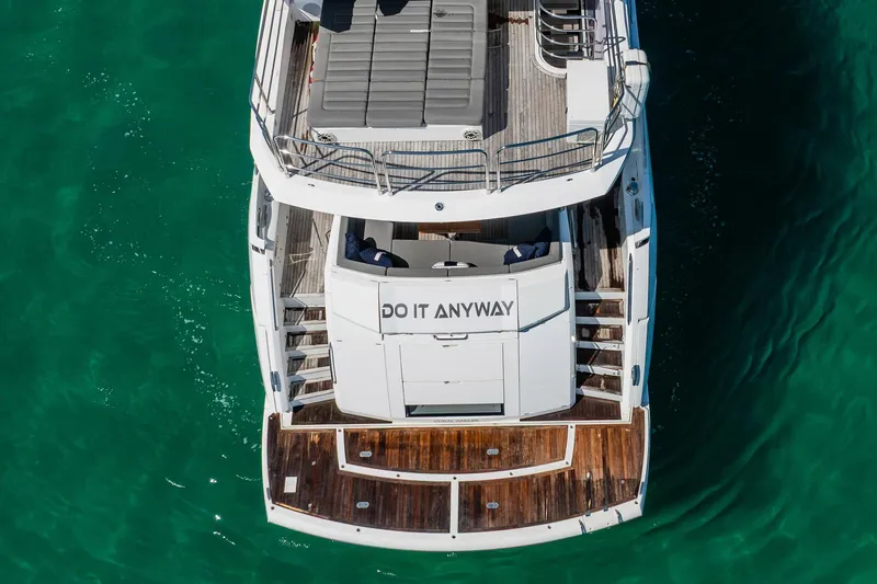 Do It Anyway Yacht Photos Pics Aerial view of 2018 Sunseeker 76 Yacht on turquoise water.
