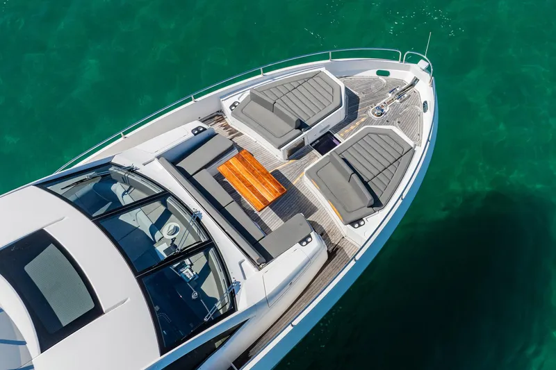 Do It Anyway Yacht Photos Pics Aerial view of 2018 Sunseeker 76 Yacht's luxurious deck on turquoise water.
