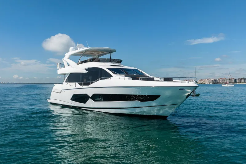 Do It Anyway Yacht Photos Pics 2018 Sunseeker 76 Yacht on calm blue waters under clear sky.