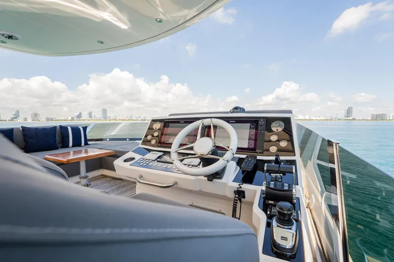 Do It Anyway Yacht Photos Pics Luxurious 2018 Sunseeker 76 Yacht helm with city skyline view.