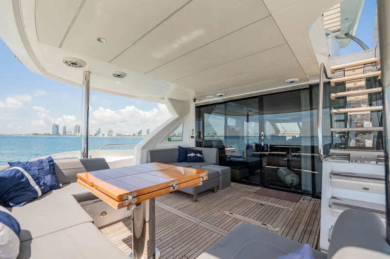 Do It Anyway Yacht Photos Pics Luxurious 2018 Sunseeker 76 Yacht deck with elegant seating and ocean view.