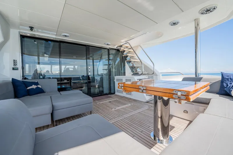 Do It Anyway Yacht Photos Pics Luxurious 2018 Sunseeker 76 Yacht interior with elegant seating and wooden table.