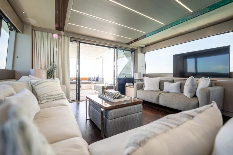 Do It Anyway Yacht Photos Pics Luxurious interior of 2018 Sunseeker 76 Yacht with modern furnishings and large windows.