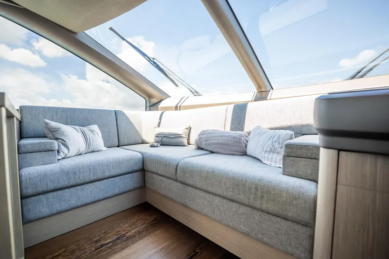 Do It Anyway Yacht Photos Pics Luxurious interior of 2018 Sunseeker 76 Yacht with plush seating and panoramic windows.