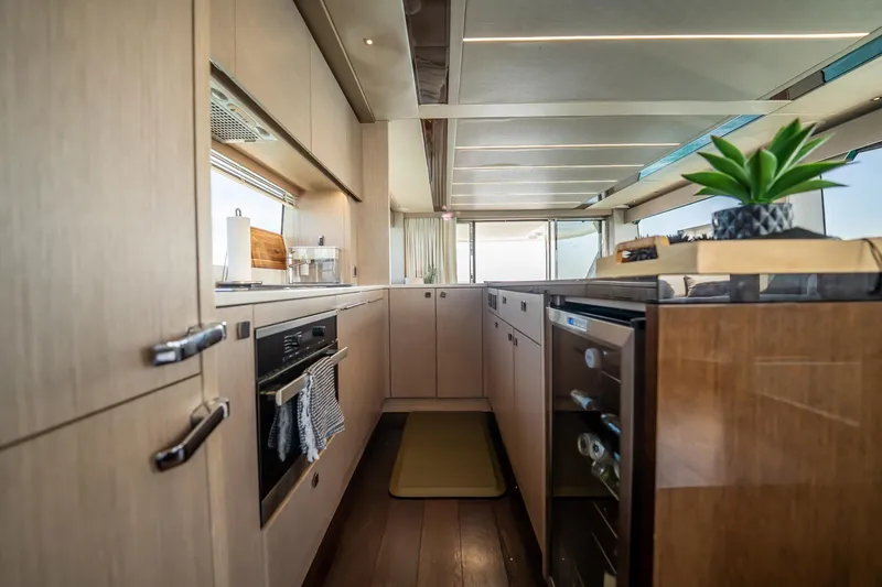 Do It Anyway Yacht Photos Pics Luxurious kitchen interior of 2018 Sunseeker 76 Yacht with modern appliances and sleek design.