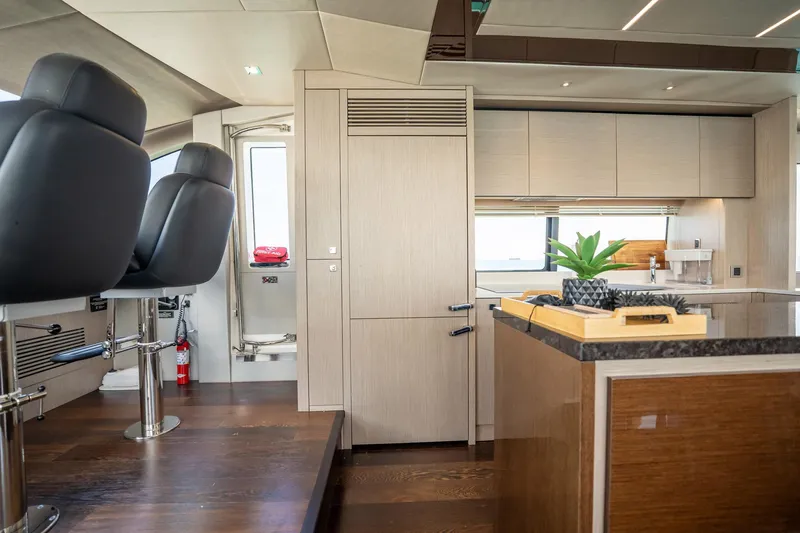 Do It Anyway Yacht Photos Pics Luxurious interior of 2018 Sunseeker 76 Yacht with modern kitchen and seating.