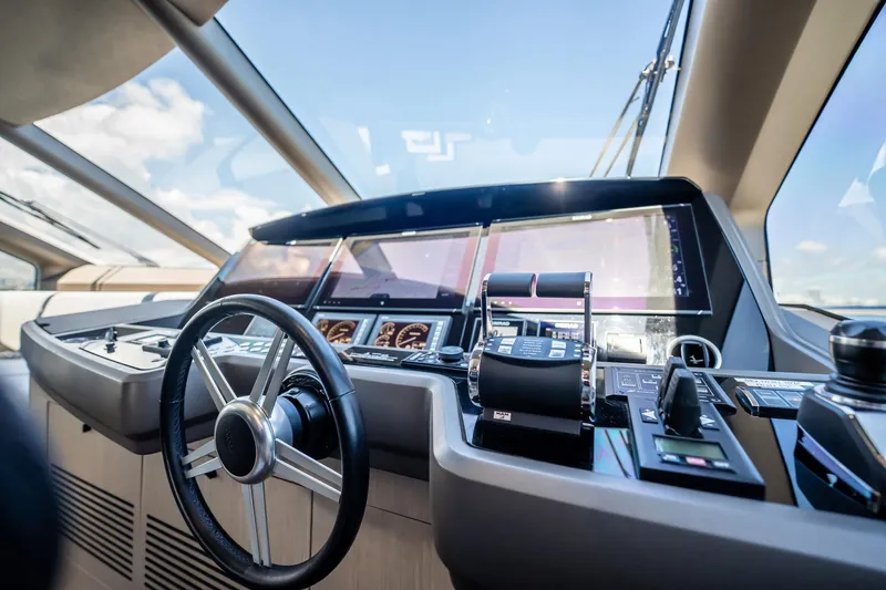 Do It Anyway Yacht Photos Pics Cockpit of 2018 Sunseeker 76 Yacht with modern navigation controls and steering wheel.