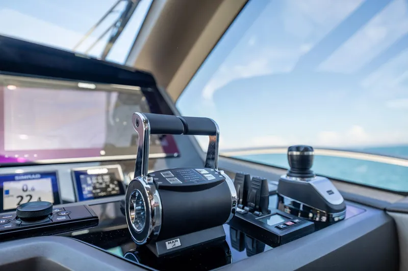 Do It Anyway Yacht Photos Pics Control panel of a 2018 Sunseeker 76 Yacht with navigation instruments and throttle levers.