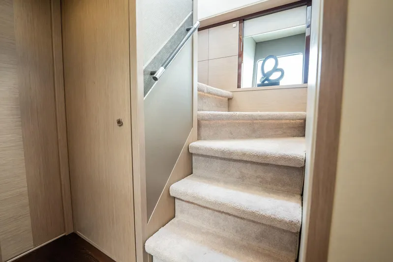 Do It Anyway Yacht Photos Pics Interior staircase of 2018 Sunseeker 76 Yacht, featuring plush carpeting and modern design.