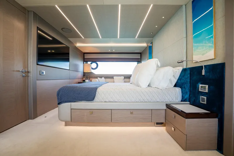 Do It Anyway Yacht Photos Pics Luxurious bedroom interior of 2018 Sunseeker 76 Yacht with modern design and elegant furnishings.