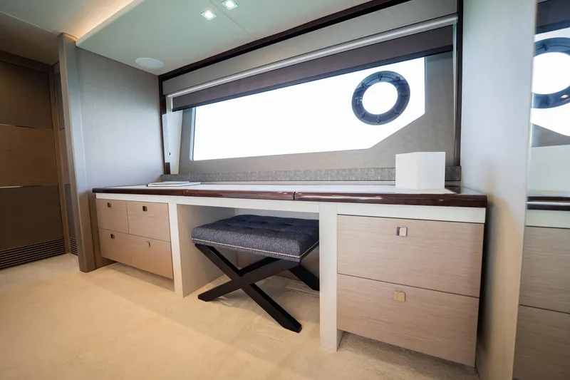 Do It Anyway Yacht Photos Pics Luxurious interior of 2018 Sunseeker 76 Yacht with elegant desk and seating.