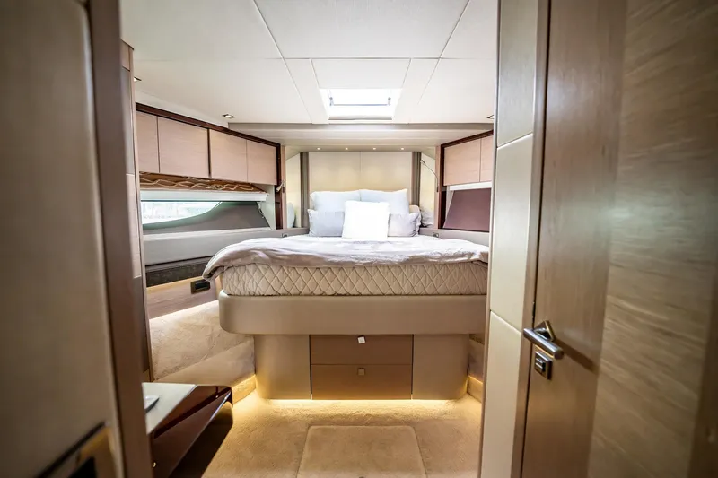 Do It Anyway Yacht Photos Pics Luxurious bedroom interior of 2018 Sunseeker 76 Yacht with elegant bedding and ambient lighting.