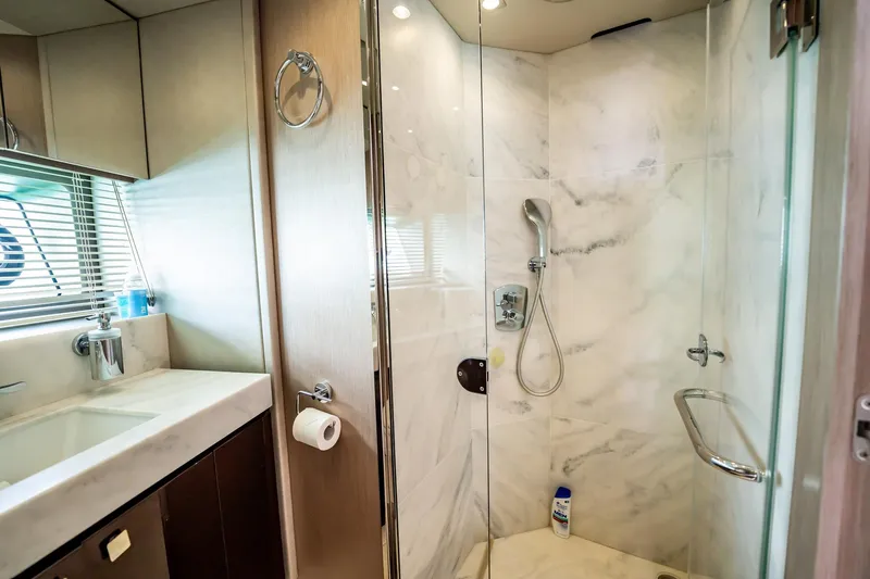 Do It Anyway Yacht Photos Pics Luxurious bathroom in 2018 Sunseeker 76 Yacht with marble shower and modern fixtures.