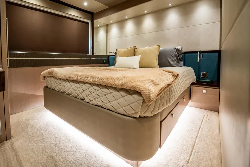 Do It Anyway Yacht Photos Pics Luxurious bedroom interior of 2018 Sunseeker 76 Yacht with elegant bedding and ambient lighting.