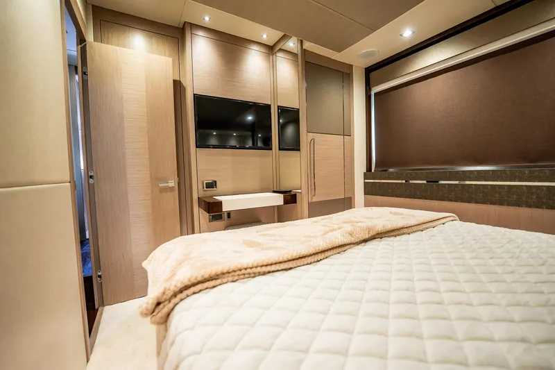 Do It Anyway Yacht Photos Pics Luxurious bedroom interior of 2018 Sunseeker 76 Yacht with modern design and cozy bedding.