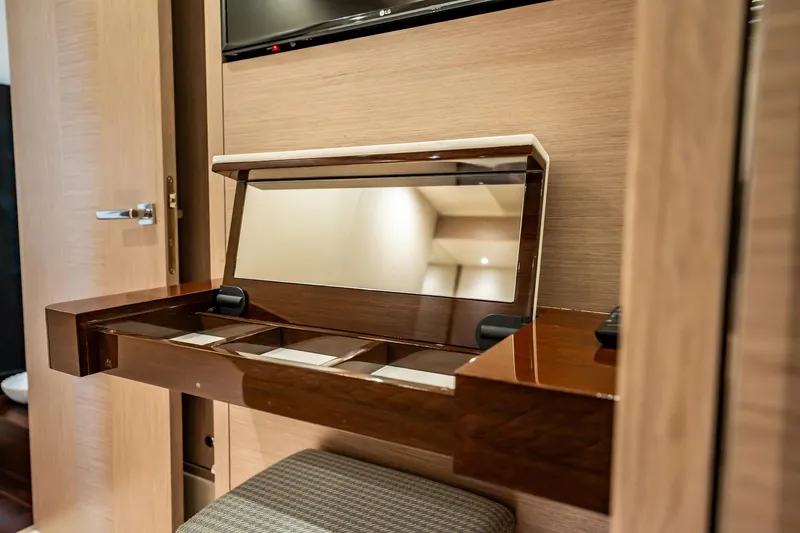 Do It Anyway Yacht Photos Pics Luxurious vanity area on 2018 Sunseeker 76 Yacht with mirror and storage compartments.
