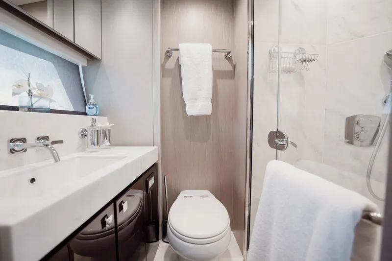 Do It Anyway Yacht Photos Pics Luxurious bathroom in 2018 Sunseeker 76 Yacht with modern fixtures and elegant design.