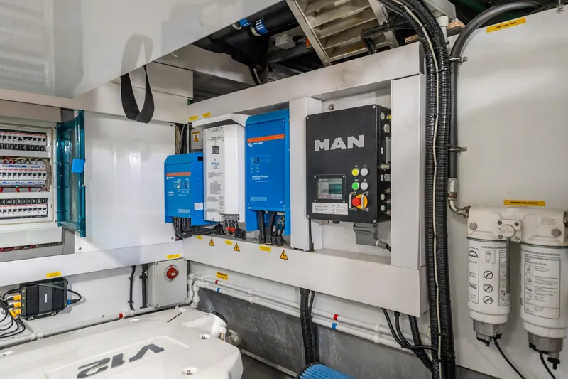 Do It Anyway Yacht Photos Pics Engine room of 2018 Sunseeker 76 Yacht with electrical panels and equipment.