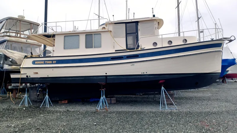 Rafiki Yacht Photos Pics Nordic Tug 37 boat from 2000 on stands in a boatyard.