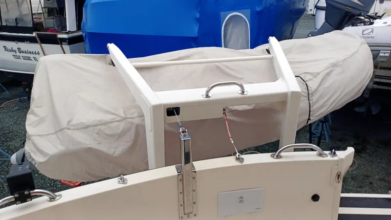 Rafiki Yacht Photos Pics Nordic Tug 37 (2000) with covered dinghy on deck, featuring sturdy railing and handles.