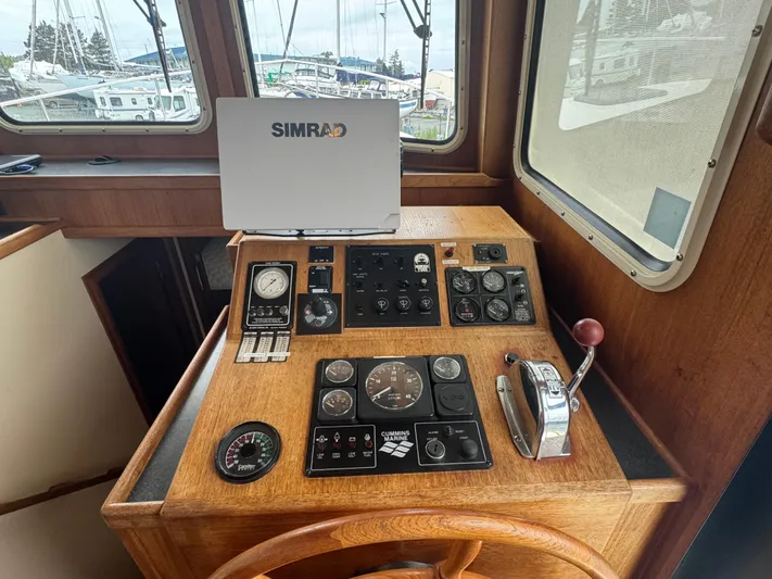 Rafiki Yacht Photos Pics Nordic Tug 37 (2000) helm with Simrad navigation, gauges, and controls.