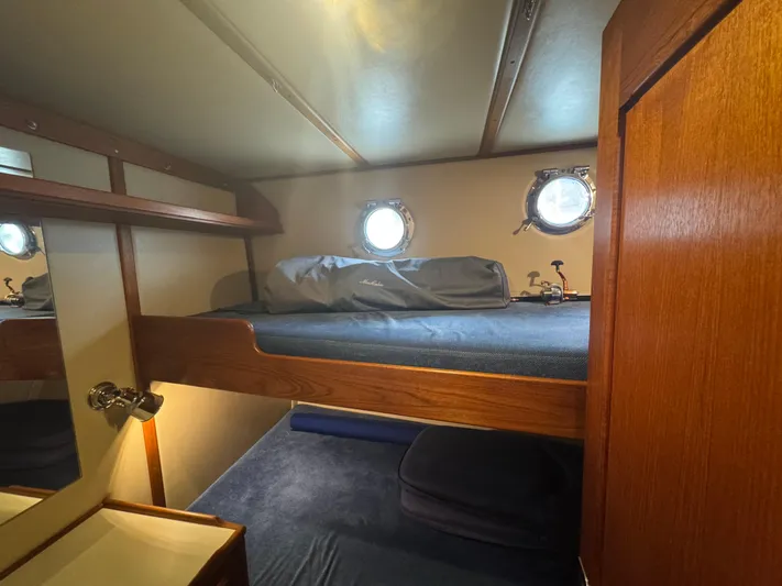 Rafiki Yacht Photos Pics Cozy cabin interior of 2000 Nordic Tug 37 with bunk beds and porthole windows.
