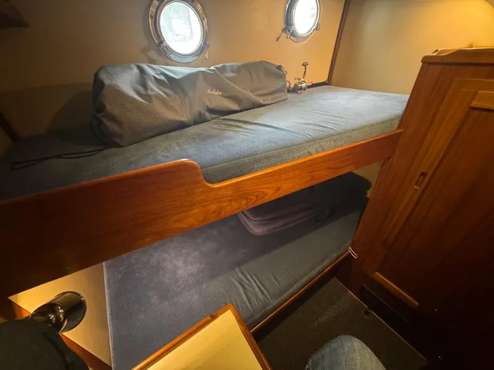 Rafiki Yacht Photos Pics Bunk beds in a 2000 Nordic Tug 37 cabin with porthole windows.