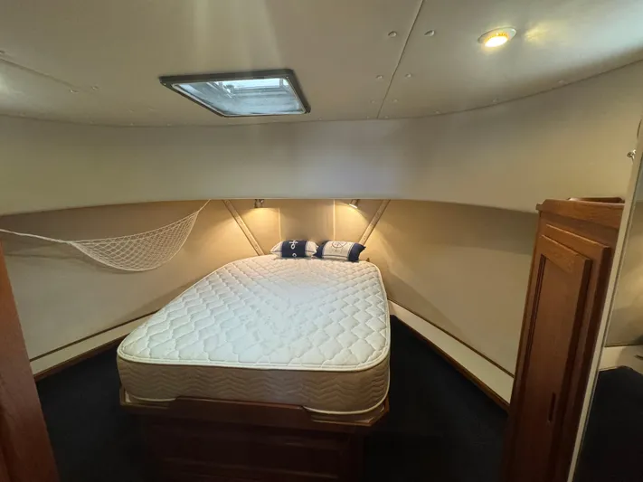 Rafiki Yacht Photos Pics Cozy cabin interior of 2000 Nordic Tug 37 with bed and storage.