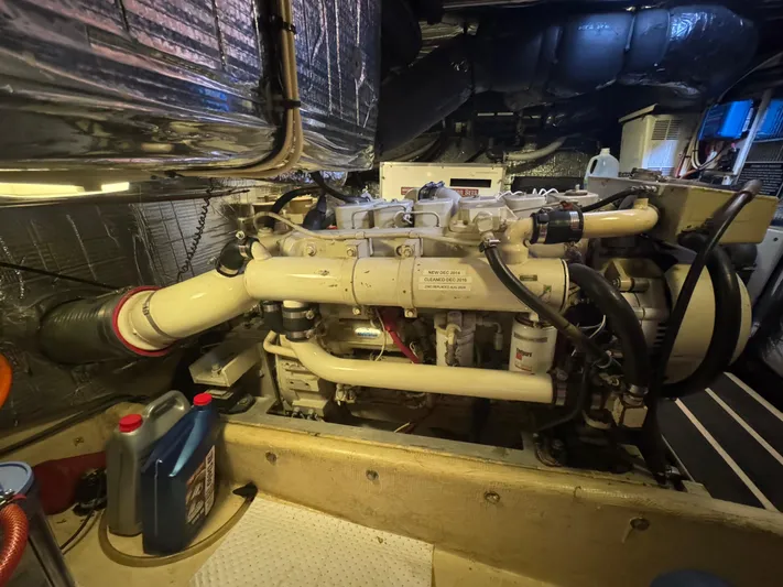 Rafiki Yacht Photos Pics Engine room of a 2000 Nordic Tug 37, showcasing mechanical components and maintenance supplies.