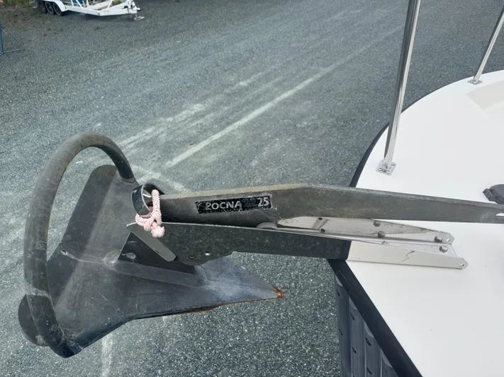 Rafiki Yacht Photos Pics Rocna 25 anchor on 2000 Nordic Tug 37 boat, docked on gravel surface.