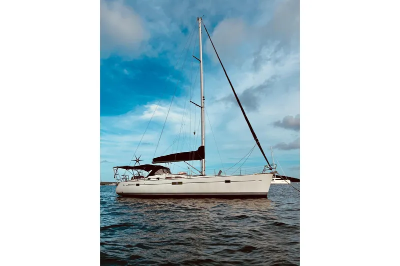 Further Yacht Photos Pics 2005 Beneteau Oceanis 473 sailboat on calm water under a blue sky.