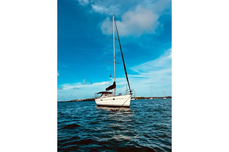 Further Yacht Photos Pics Sailing yacht Beneteau Oceanis 473, 2005 model, on calm blue waters under a clear sky.