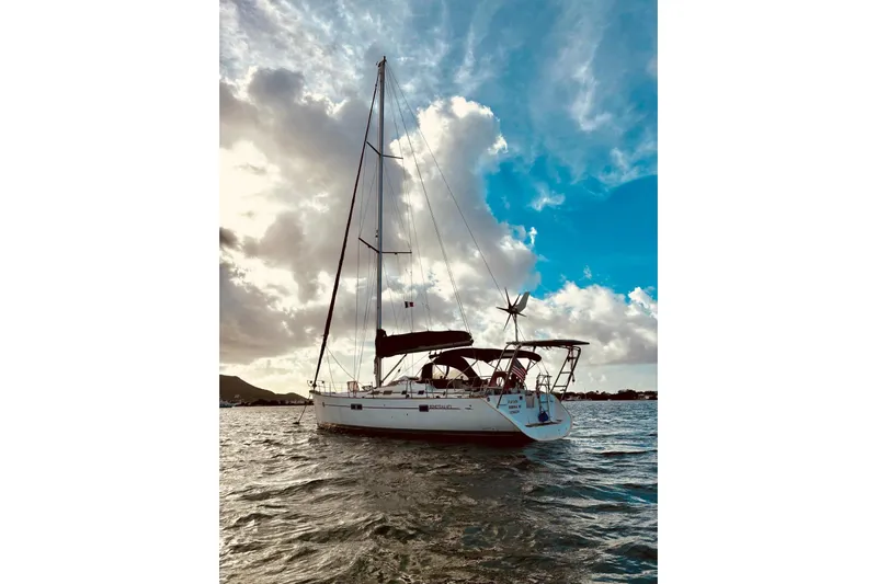 Further Yacht Photos Pics Sailing yacht Beneteau Oceanis 473, 2005 model, on open water under a dramatic sky.