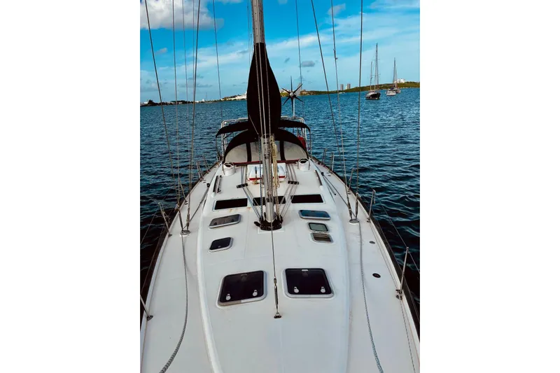 Further Yacht Photos Pics 2005 Beneteau Oceanis 473 sailboat on calm waters under a clear blue sky.