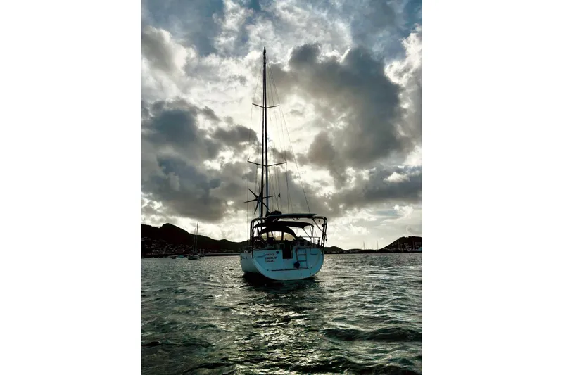 Further Yacht Photos Pics Sailing yacht Beneteau Oceanis 473 (2005) on water with dramatic cloudy sky.