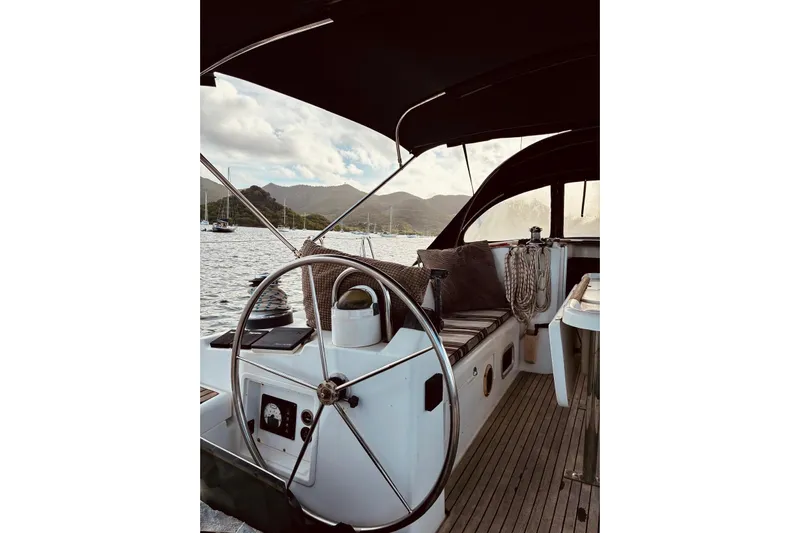 Further Yacht Photos Pics 2005 Beneteau Oceanis 473 sailboat cockpit with scenic mountain and ocean view.