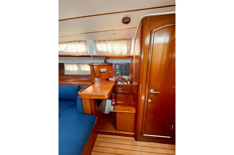 Further Yacht Photos Pics Interior of 2005 Beneteau Oceanis 473 yacht with wooden cabinetry and seating.