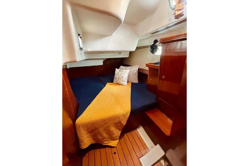 Further Yacht Photos Pics Cozy cabin interior of 2005 Beneteau Oceanis 473 sailboat with wooden finish.