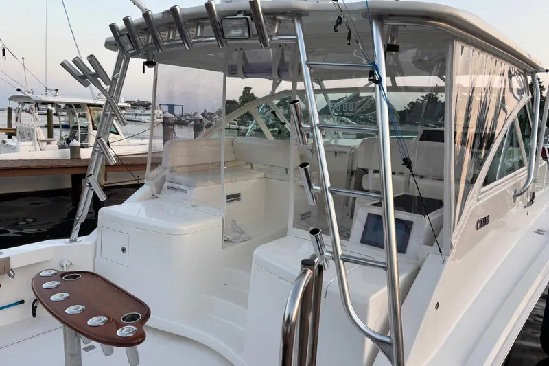  Yacht Photos Pics 2010 Cabo 36 Express boat with fishing rod holders and spacious cockpit at marina.