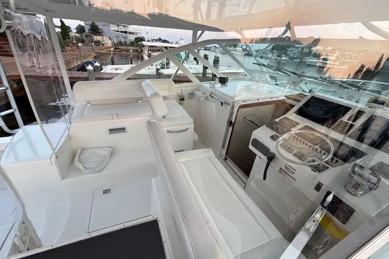  Yacht Photos Pics 2010 Cabo 36 Express yacht cockpit with white seating and modern navigation equipment.