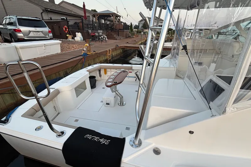  Yacht Photos Pics 2010 Cabo 36 Express boat docked, featuring spacious deck and fishing chair.