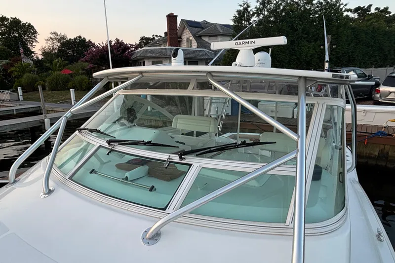  Yacht Photos Pics 2010 Cabo 36 Express boat docked, featuring Garmin radar and sleek windshield design.