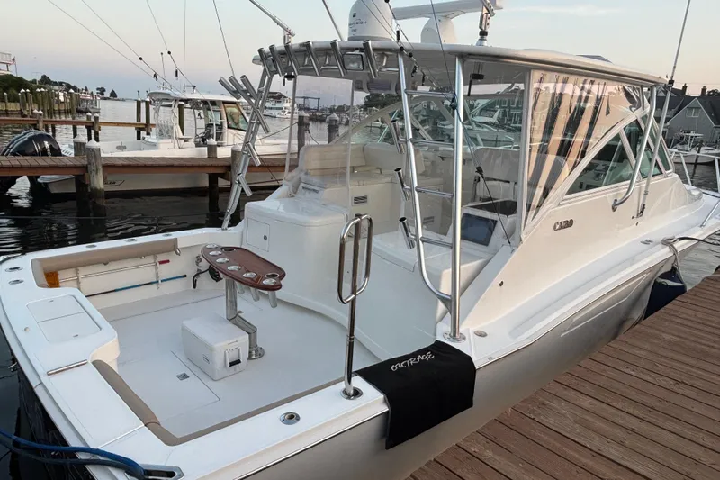  Yacht Photos Pics 2010 Cabo 36 Express boat docked, featuring spacious deck and fishing equipment.