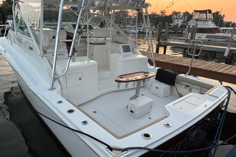  Yacht Photos Pics 2010 Cabo 36 Express boat docked at marina during sunset, showcasing spacious deck and seating.