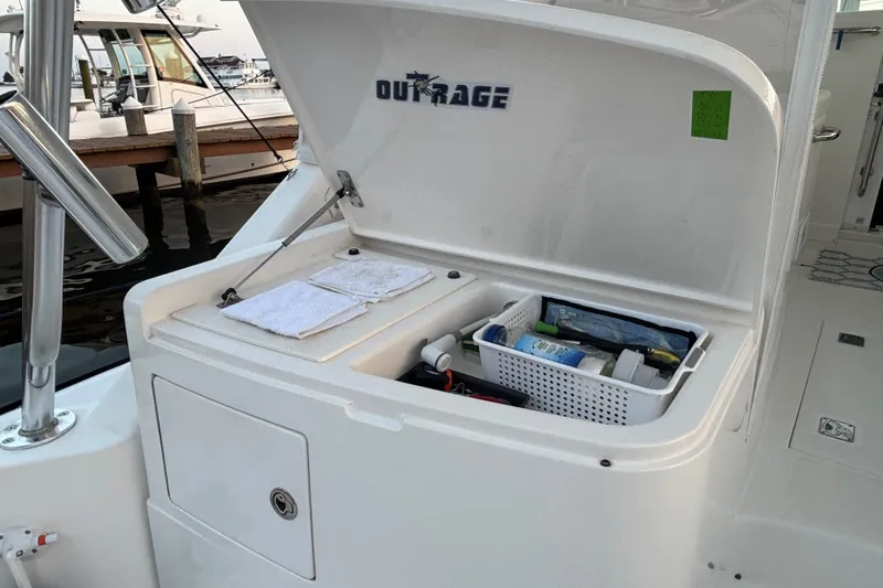  Yacht Photos Pics Open storage compartment on 2010 Cabo 36 Express boat, featuring organized supplies and towels.