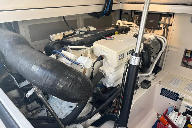  Yacht Photos Pics Engine compartment of a 2010 Cabo 36 Express boat, featuring CAT Marine engine components.